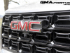 2023-gmc-canyon-elevation-sterling-metallic-gxd-first-drive-exterior-025-gmc-logo-badge-on-grille-front-camera
