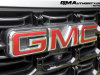 2023-gmc-canyon-elevation-sterling-metallic-gxd-first-drive-exterior-032-gmc-logo-badge-on-grille-front-camera