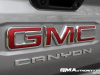 2023-gmc-canyon-elevation-sterling-metallic-gxd-first-drive-exterior-073-gmc-logo-badge-on-tailgate