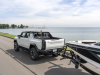 2023-gmc-hummer-ev-edition-1-pickup-press-photos-exterior-016-side-rear-three-quarters-towing-boat-trailer