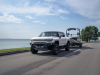 2023-gmc-hummer-ev-edition-1-pickup-press-photos-exterior-017-front-three-quarters-towing-boat-trailer