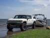 2023-gmc-hummer-ev-edition-1-pickup-press-photos-exterior-018-front-three-quarters-towing-boat-trailer