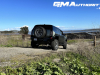2024-gmc-hummer-ev-suv-3x-edition-1-moonshot-green-matte-g7w-first-drive-exterior-035-side-rear-three-quarters-spare-tire-rear-wheel-steer-extract-mode