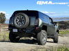 2024-gmc-hummer-ev-suv-3x-edition-1-moonshot-green-matte-g7w-first-drive-exterior-036-side-rear-three-quarters-spare-tire-rear-wheel-steer-extract-mode