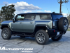 2024-gmc-hummer-ev-suv-3x-edition-1-moonshot-green-matte-g7w-first-drive-exterior-053-side-rear-three-quarters-extract-mode