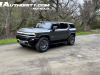 2024-gmc-hummer-ev-suv-3x-edition-1-moonshot-green-matte-g7w-first-drive-exterior-079-side-front-three-quarters-low-ride-height