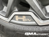 2024-gmc-hummer-ev-suv-3x-edition-1-moonshot-green-matte-g7w-first-drive-exterior-151-hummer-ev-logo-badge-on-22-inch-wheel-phz