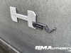 2024-gmc-hummer-ev-suv-3x-edition-1-moonshot-green-matte-g7w-first-drive-exterior-155-hummer-ev-logo-badge-on-door