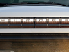 2024-gmc-hummer-ev-suv-exterior-021-front-driving-through-mud-hummer-logo-on-grille