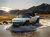 2024-gmc-hummer-ev-suv-exterior-022-front-three-quarters-driving-through-water
