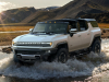 2024-gmc-hummer-ev-suv-exterior-023-front-three-quarters-driving-through-water