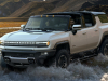 2024-gmc-hummer-ev-suv-exterior-024-front-three-quarters-driving-through-water