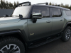 2024-gmc-hummer-ev-suv-exterior-089-moonshot-green-matte-edition-1-side-with-roof-rack-front-accessory-lights