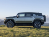 2024-gmc-hummer-ev-suv-extreme-off-road-package-z6x-moonshot-green-matte-g7w-press-photos-exterior-007-side