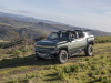 2024-gmc-hummer-ev-suv-extreme-off-road-package-z6x-moonshot-green-matte-g7w-press-photos-exterior-023-side-front-three-quarters-infinity-roof-panels-removed