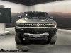 2024-gmc-hummer-ev-suv-extreme-offroad-package-media-briefing-moonshot-green-matte-g7w-exterior-001-front-front-fascia-headlights-grille