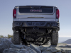 2023-sierra-1500-at4x-aev-edition-press-photos-exterior-010-rear-aev-rear-bumper-skid-plates-black-contrast-inner-multipro-tailgate-spare-tire-and-wheel