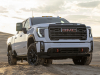 2024-gmc-sierra-hd-at4-press-photos-exterior-003-front-three-quarters-cab-lights-hood-scoop-intake-drl-daytime-running-lights-grille-gmc-logo-badge-fog-lights-red-tow-hooks