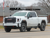 2024-gmc-sierra-hd-at4-summit-white-gaz-20-inch-10-spoke-machined-aluminum-wheels-with-grazen-metallic-painted-accents-q86-on-the-road-photos-exterior-001