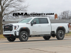 2024-gmc-sierra-hd-at4-summit-white-gaz-20-inch-10-spoke-machined-aluminum-wheels-with-grazen-metallic-painted-accents-q86-on-the-road-photos-exterior-003