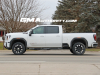 2024-gmc-sierra-hd-at4-summit-white-gaz-20-inch-10-spoke-machined-aluminum-wheels-with-grazen-metallic-painted-accents-q86-on-the-road-photos-exterior-005