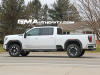 2024-gmc-sierra-hd-at4-summit-white-gaz-20-inch-10-spoke-machined-aluminum-wheels-with-grazen-metallic-painted-accents-q86-on-the-road-photos-exterior-006