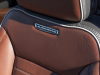 2024-gmc-sierra-hd-denali-ultimate-press-photos-interior-007-driver-seat-detail-ultimate-badge-script