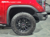 2023-gmc-sierra-at4x-1500-volcanic-red-tintcoat-gnt-2022-naias-detroit-live-photos-exterior-004-goodyear-wrangler-territory-mt-tire-wheel