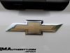 2024-chevrolet-silverado-ev-wt-work-truck-first-drive-exterior-087-gold-chevy-logo-badge-bowtie-on-tailgate