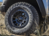 2024-gmc-canyon-at4x-aev-edition-media-drive-exterior-007-goodyear-wrangler-territory-mt-tire-17-inch-gloss-black-wheel