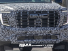 2025-gmc-yukon-xl-denali-ultimate-prototype-spy-shots-little-camo-march-2024-exterior-002-front-front-fascia-grille-drl-daytime-running-lights