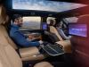 2025-cadillac-escalade-iq-sport-reveal-photos-interior-014-rear-seat-headrest-screens-center-console-fold-out-table
