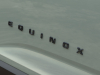 2025-chevrolet-equinox-activ-press-photos-exterior-009-black-equinox-logo-badge-on-door
