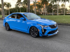 2022-cadillac-ct4-v-blackwing-gma-garage-electric-blue-exterior-004-side-front-three-quarters