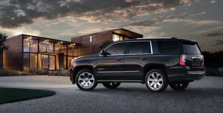 2015 GMC Acadia Denali rear three quarter angle.