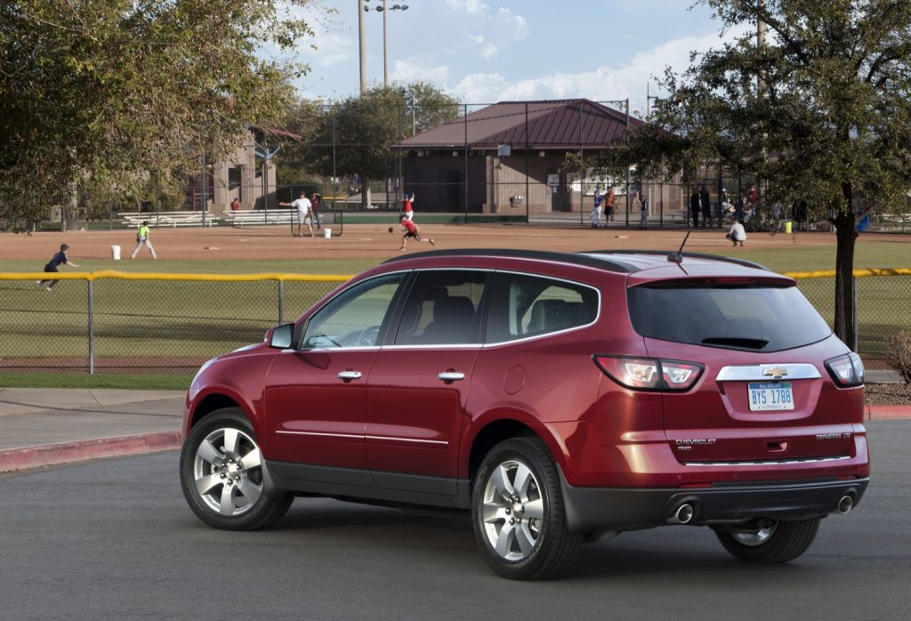 A rear three-quarters view of a 2015 Chevy Traverse.