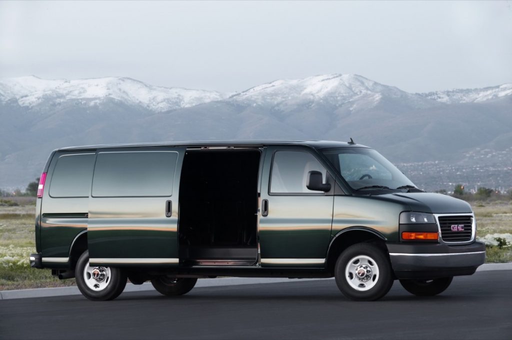 The GMC Savana full-size van with its sliding door open.