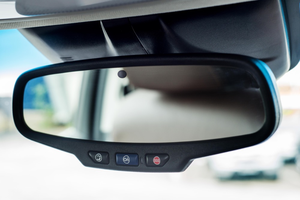 A rearview mirror with an OnStar button.