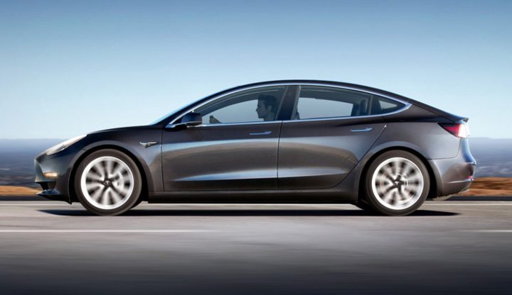 Tesla Model 3 side profile driving.