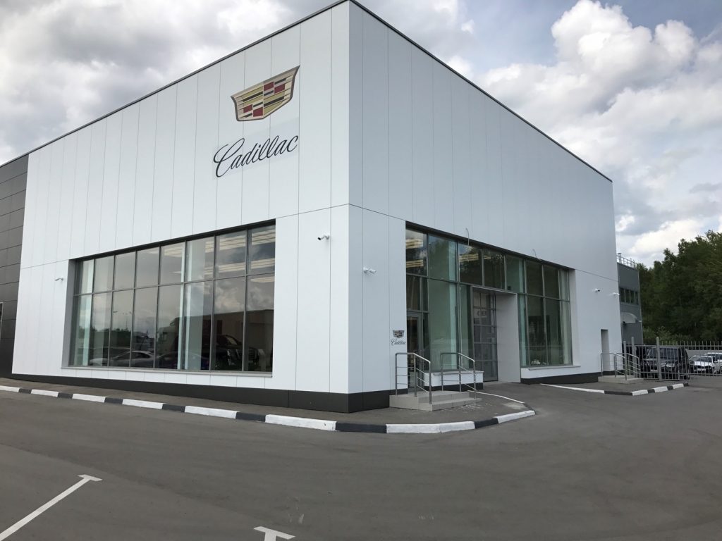 The entrance of a Cadillac dealership.