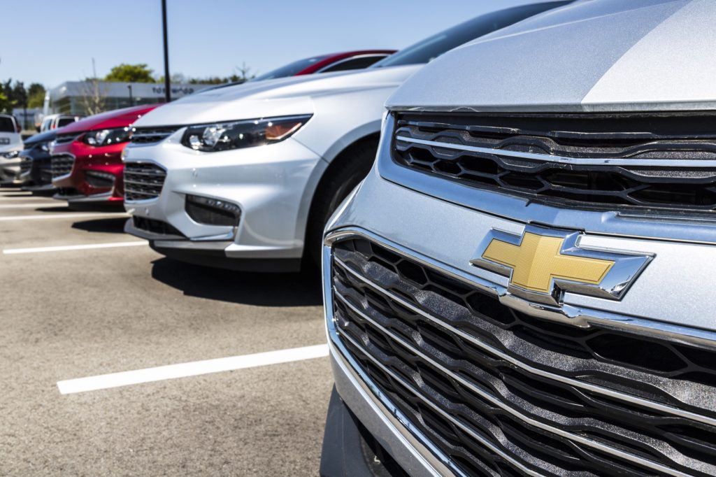 Chevy Malibus lined up at a dealership.
