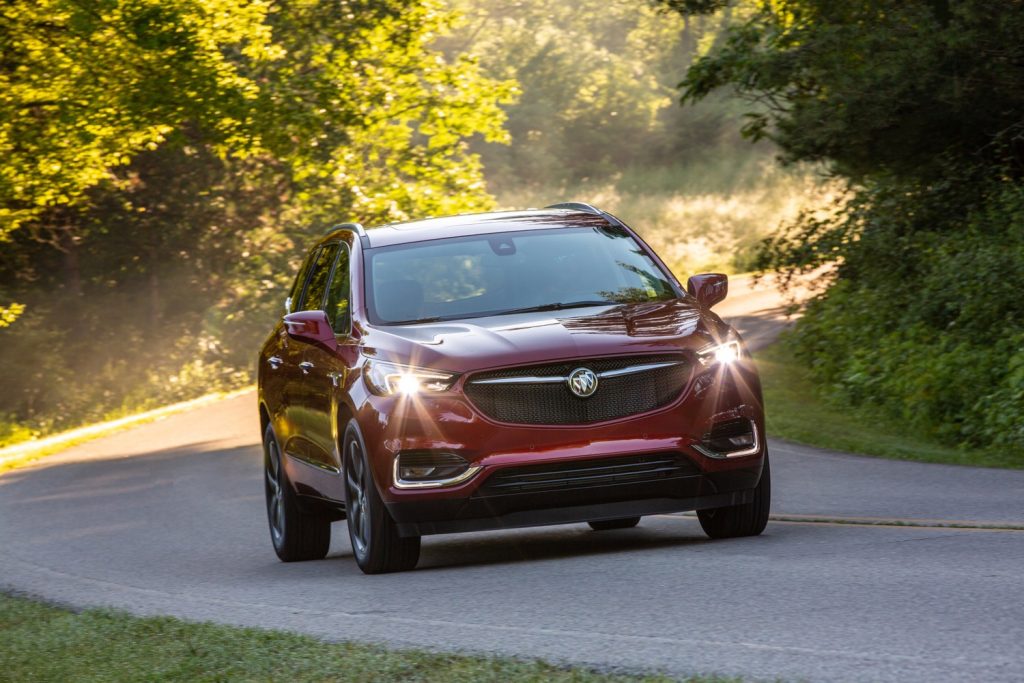 The Buick Enclave drives down a two-lane road.