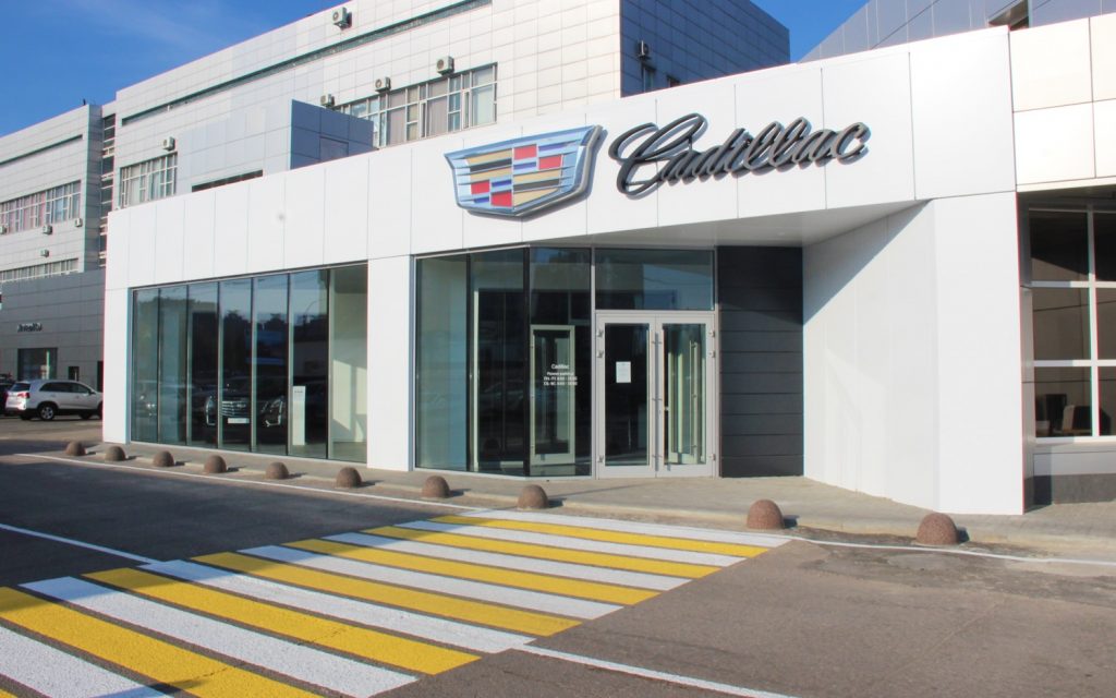 Main entrance of a Cadillac dealership.