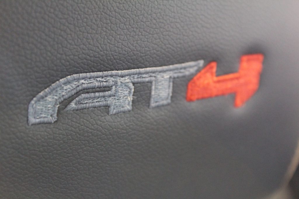 The AT4 logo on a GMC Terrain seat back.