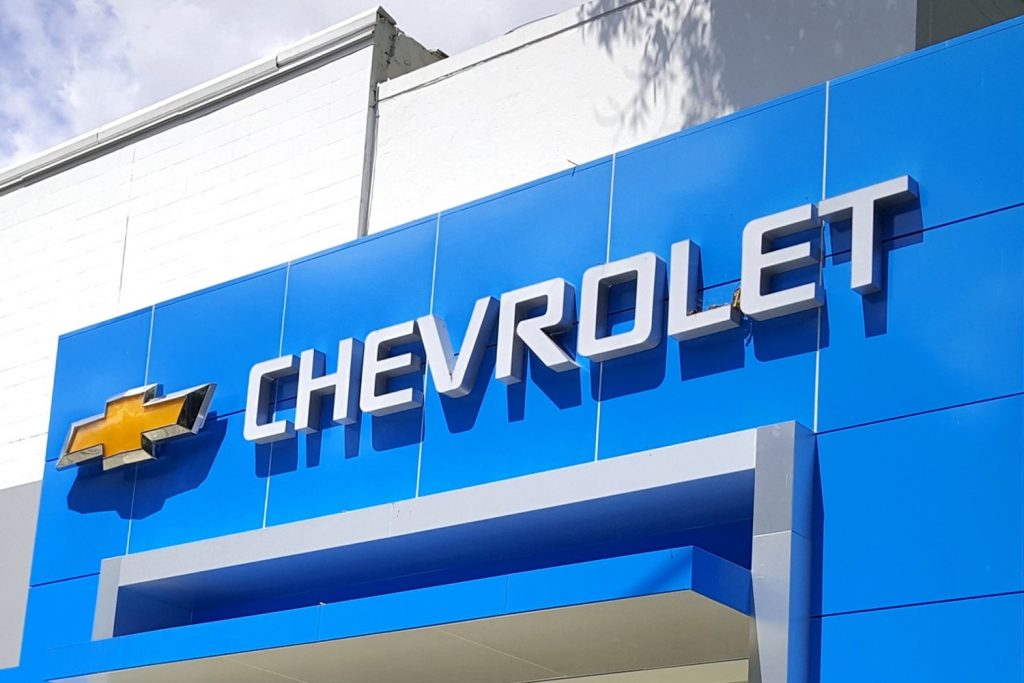 Signage in front of a Chevy dealer.