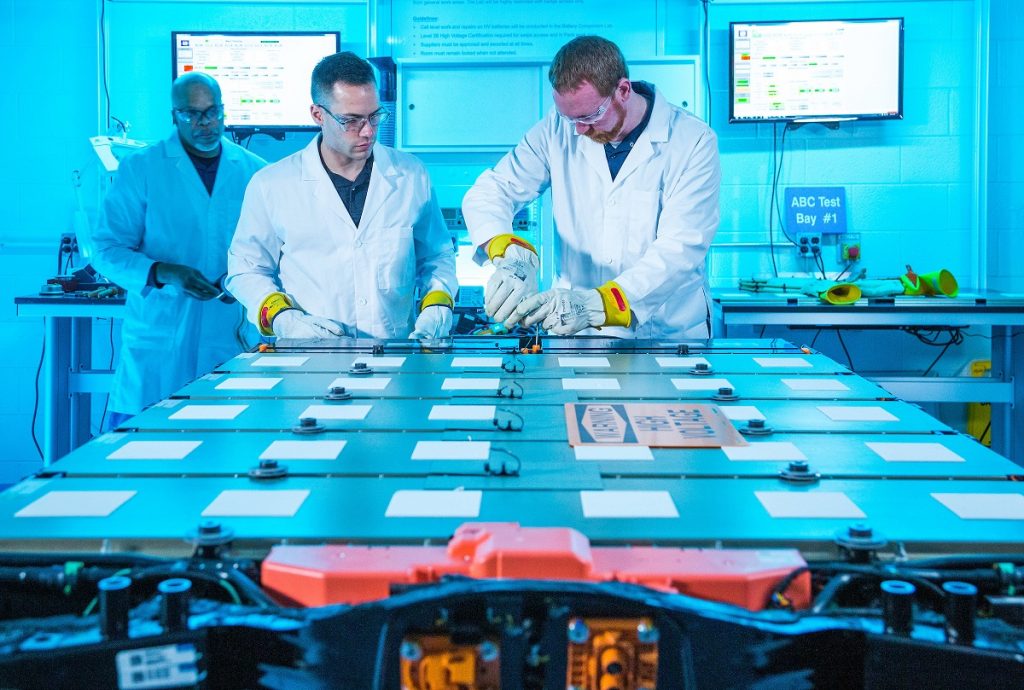 Ultium battery cell production with several technicians in lab coats.