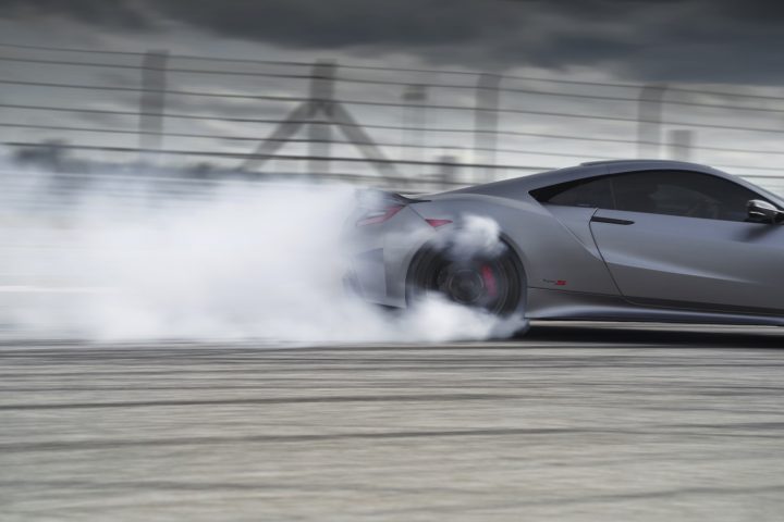 The second-generation Acura NSX smokes its rear tires.