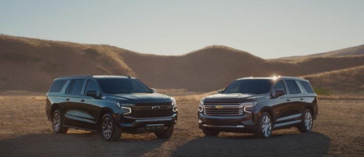 Front three quarters view of the Chevy Suburban and Chevy Tahoe. 