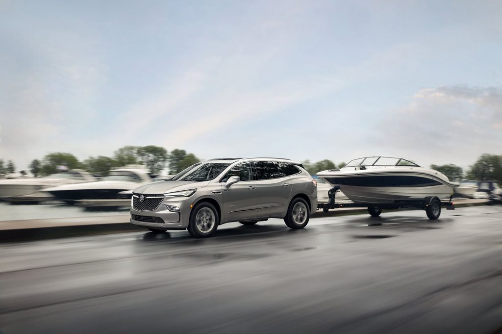 Shown here is the 2022 Buick Enclave, in the range-topping Avenir trim level, towing a boat. 
