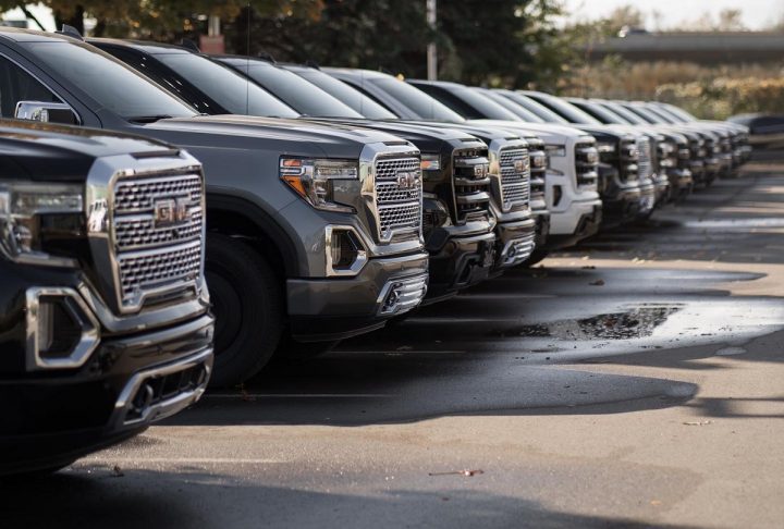 GMC Sierra trucks at a dealership where dealer fees would be affected by the CARS rule.